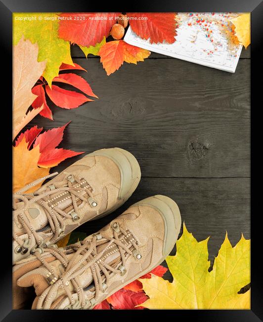 Autumn leaves, tracking boots and maps on a black background of an old tree Framed Print by Sergii Petruk