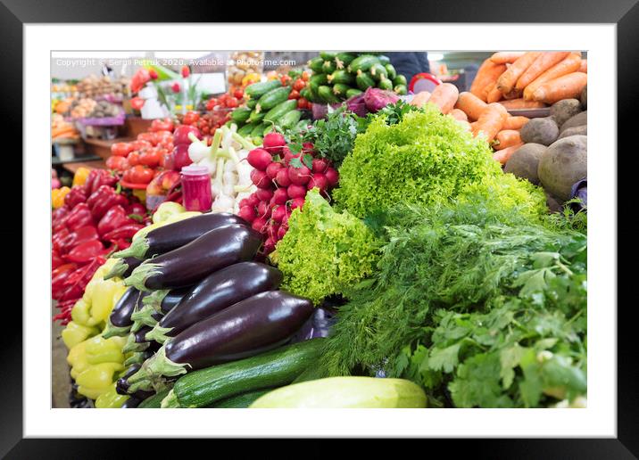 Juicy greens of lettuce, dill, parsley and eggplant, radish, zucchini lie on the market counter for sale Framed Mounted Print by Sergii Petruk