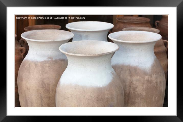 Large clay amphorae for water in a row for sale Framed Mounted Print by Sergii Petruk