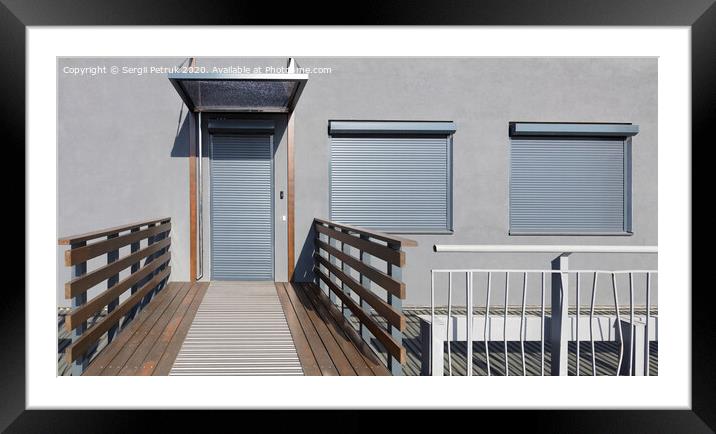 Metal blinds on the doors and windows of the facade of the house Framed Mounted Print by Sergii Petruk