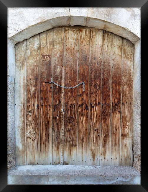 Ancient trapezoidal antique wooden doors with a metal lock in the middle Framed Print by Sergii Petruk
