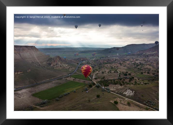 A balloons is flying over the valley in Cappadocia Framed Mounted Print by Sergii Petruk