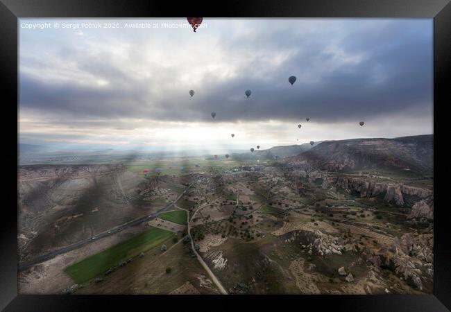 Balloons fly over the valleys in Cappadocia Framed Print by Sergii Petruk
