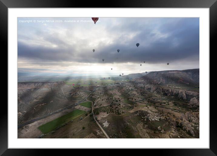 Balloons fly over the valleys in Cappadocia Framed Mounted Print by Sergii Petruk