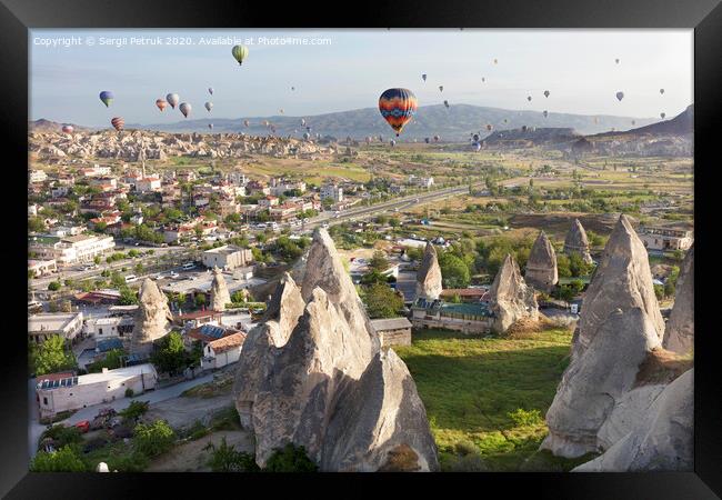 Dozens of balloons fly over the valleys in Cappadocia Framed Print by Sergii Petruk