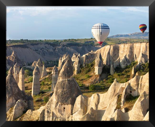A balloon is flying over the valley in Cappadocia Framed Print by Sergii Petruk