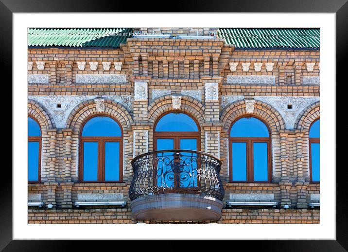 The wooden windows of the old architecture building reflect the blue clear sky Framed Mounted Print by Sergii Petruk