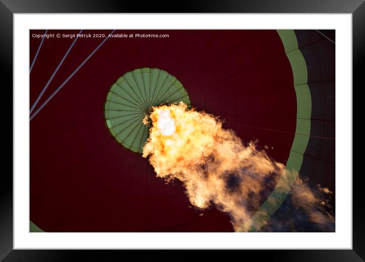 The flame of a gas burner inflates a balloon Framed Mounted Print by Sergii Petruk
