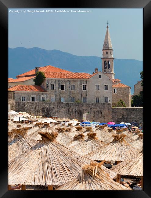 Thatched roofs of beach umbrellas in the bright sun Framed Print by Sergii Petruk