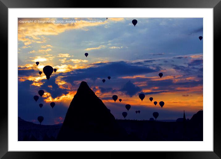 Attraction dozens of balloons climbed into the night sky above the conical peaks of the rocks in Cappadocia Framed Mounted Print by Sergii Petruk