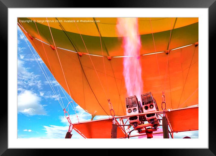 Fire of coral color comes out of a powerful gas torch and fills balloon balloon with hot air. Framed Mounted Print by Sergii Petruk