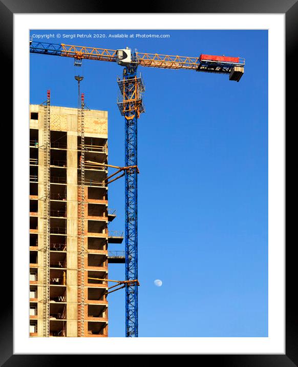 Facade and construction crane near the modern concrete building under construction. Framed Mounted Print by Sergii Petruk