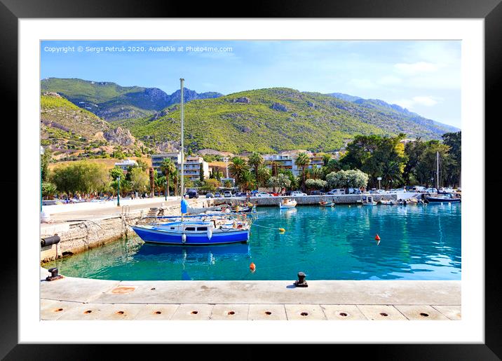 View of the pier of the bay, where old fishing schooners, boats and boats are moored in the clear waters of the Ionian Sea. Framed Mounted Print by Sergii Petruk