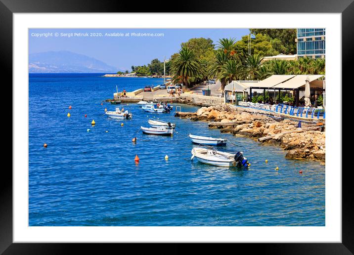 Powerboats and boats are anchored along the rocky coast of the Ionian Sea. Framed Mounted Print by Sergii Petruk