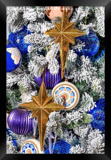 Stars and Christmas toys hang on a Christmas tree. Framed Print by Sergii Petruk
