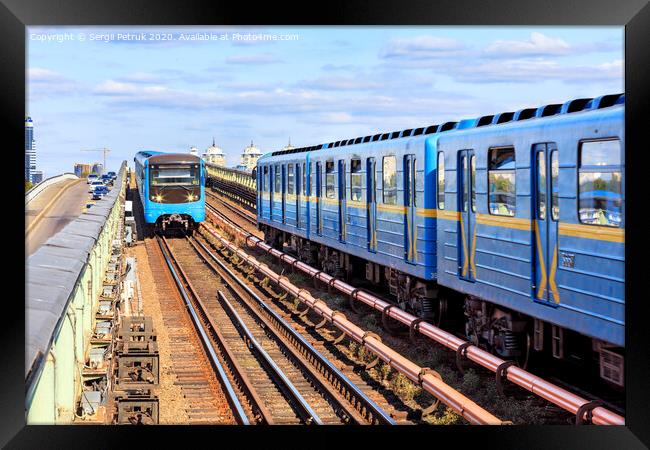 Two metro trains go towards each other along the metro bridge in Kyiv across the Dnipro River. Framed Print by Sergii Petruk