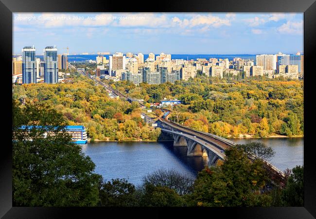 Landscape of the autumn city of Kyiv with a view of the Dnipro River, a branch and a subway bridge, Hydropark and the left bank of the Rusanovka district. Framed Print by Sergii Petruk