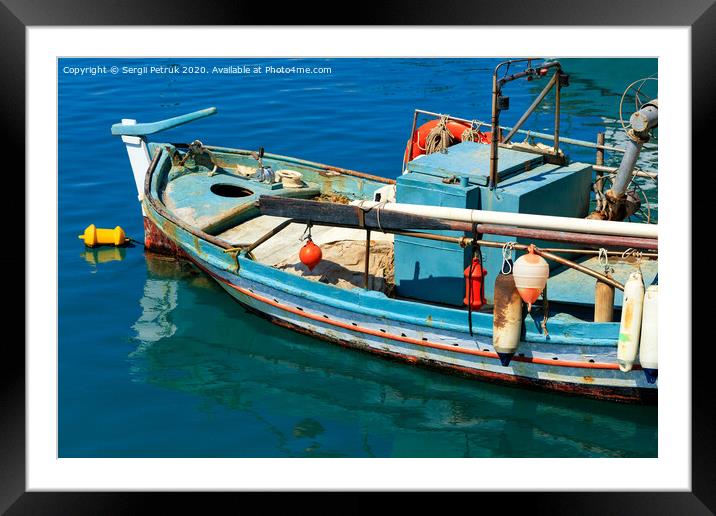 An old fishing boat anchored in the clear waters of the Ionian Sea. Framed Mounted Print by Sergii Petruk