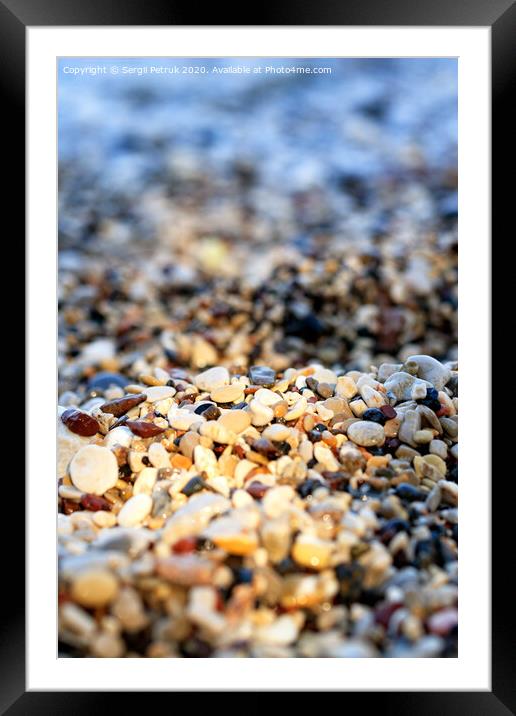 Beach pebbles backlit by a bright sunbeam. Framed Mounted Print by Sergii Petruk