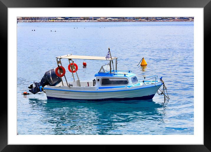 View of a small rescue boat with a powerful motor on the background of the beach coastline. Framed Mounted Print by Sergii Petruk