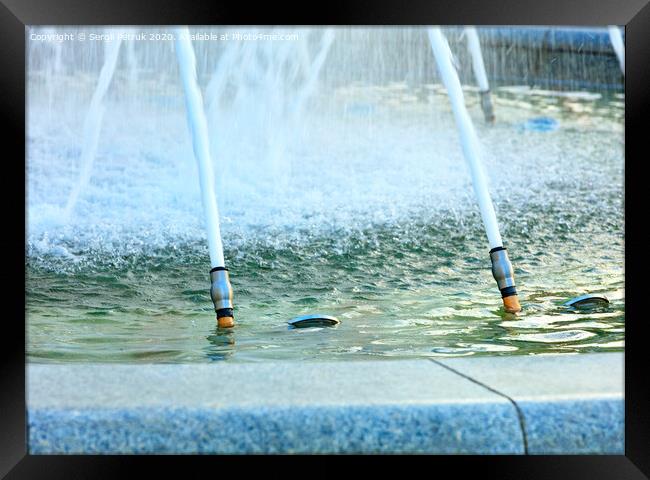 Powerful jets of water in a city fountain made of polished granite burst from metal nozzles. Framed Print by Sergii Petruk