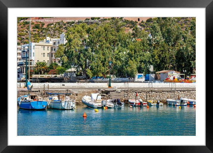 The picturesque promenade of Loutraki Bay, Greece, where old fishing schooners, boats and boats moor in the clear waters of the Ionian Sea. Framed Mounted Print by Sergii Petruk