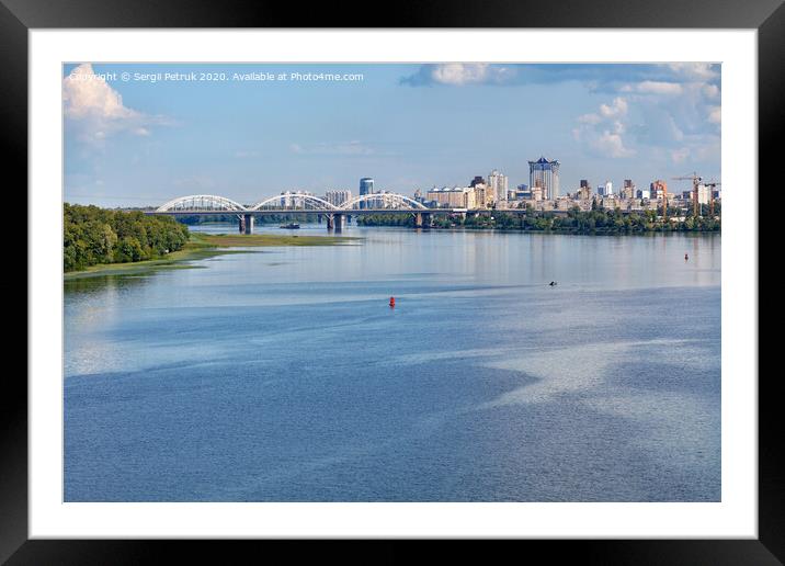 A view of the Dnipro, the railway bridge and new residential areas of Kyiv on the horizon of the coast. Framed Mounted Print by Sergii Petruk