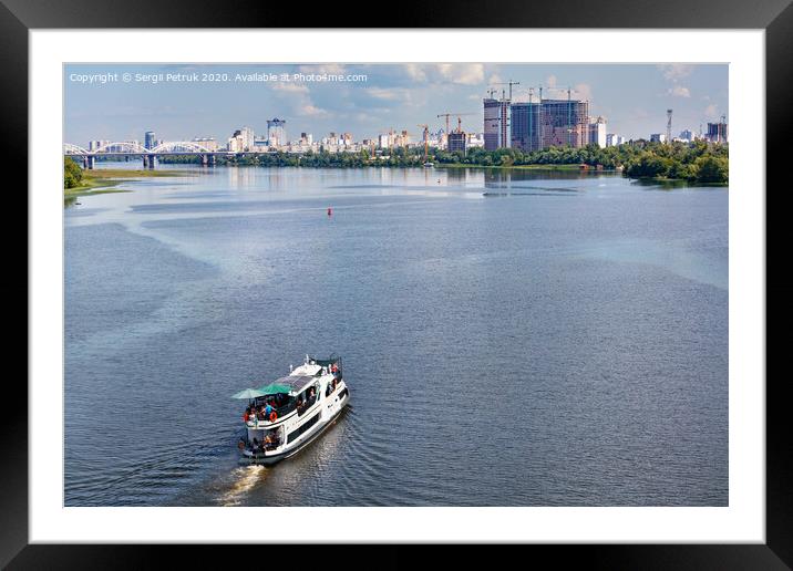 A river tram carries tourists along the Dnipro River along the left bank of Kyiv, top view. Framed Mounted Print by Sergii Petruk