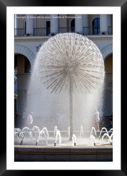 A beautiful city fountain in the shape of a huge dandelion refreshes passers-by against the background of the arched-column facade of the Kyiv City Conservatory. Framed Mounted Print by Sergii Petruk