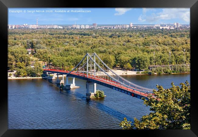 Pedestrian park bridge over the Dnipro river in Kyiv on a sunny summer day. Framed Print by Sergii Petruk
