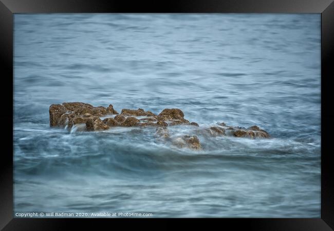 Rocks in the sea Framed Print by Will Badman