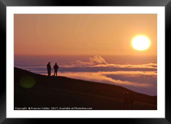 Two people silhouetted viewing the sunset and fog Framed Mounted Print by Frances Valdes