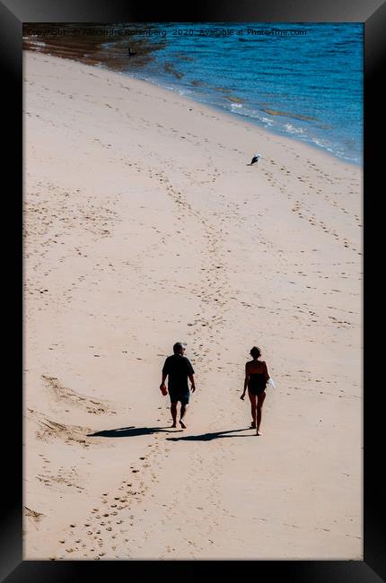 Man and woman walking on sandy beach  Framed Print by Alexandre Rotenberg