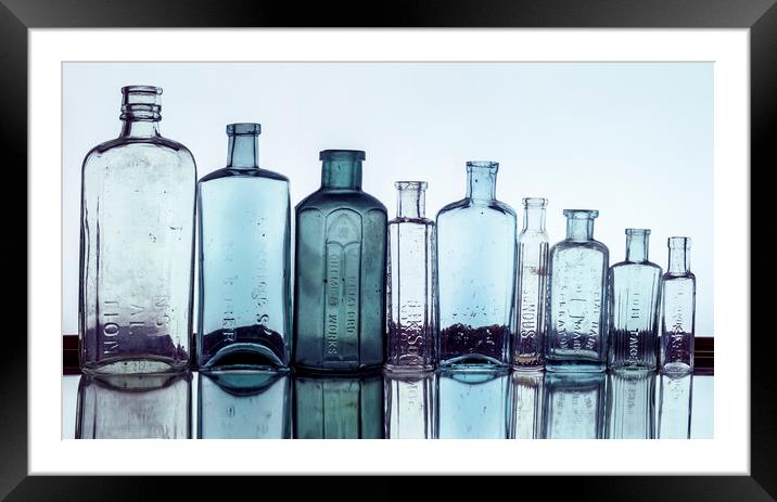 Line of Bottles Framed Mounted Print by Kelly Bailey