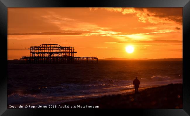 West pier sunset watcher Framed Print by Roger Utting