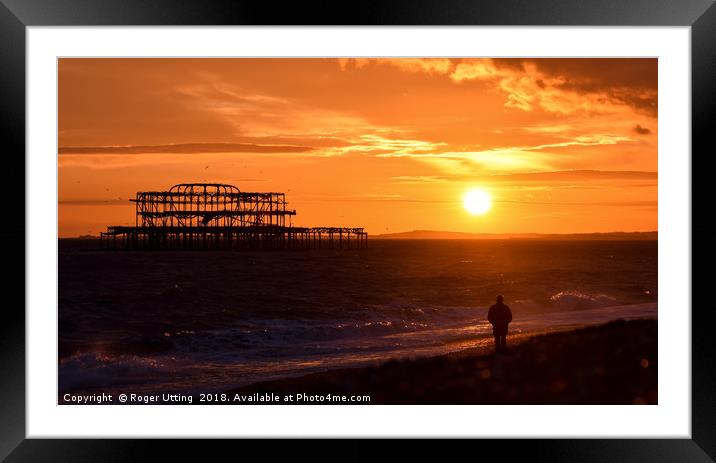 West pier sunset watcher Framed Mounted Print by Roger Utting