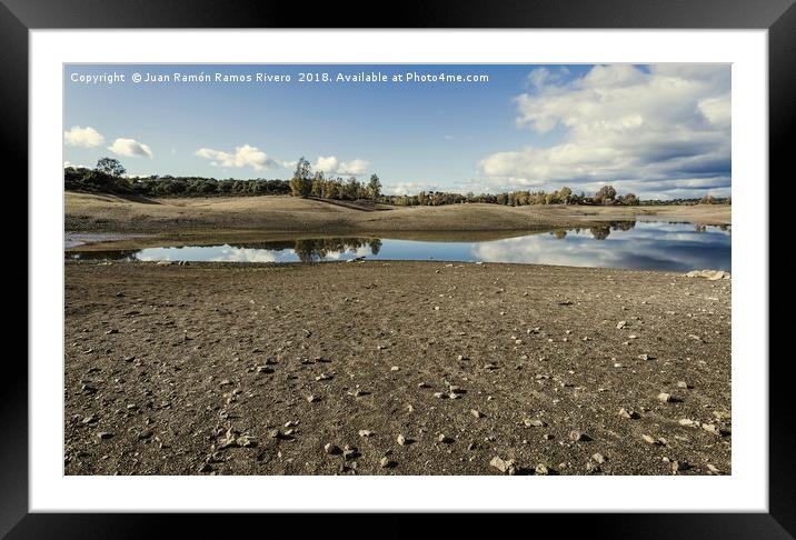 Stones on the shore of the lake Framed Mounted Print by Juan Ramón Ramos Rivero