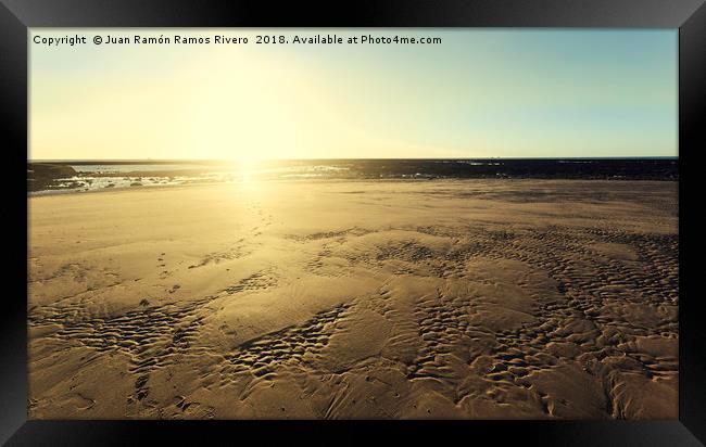 Sunset sun illuminating the sand of the beach Framed Print by Juan Ramón Ramos Rivero