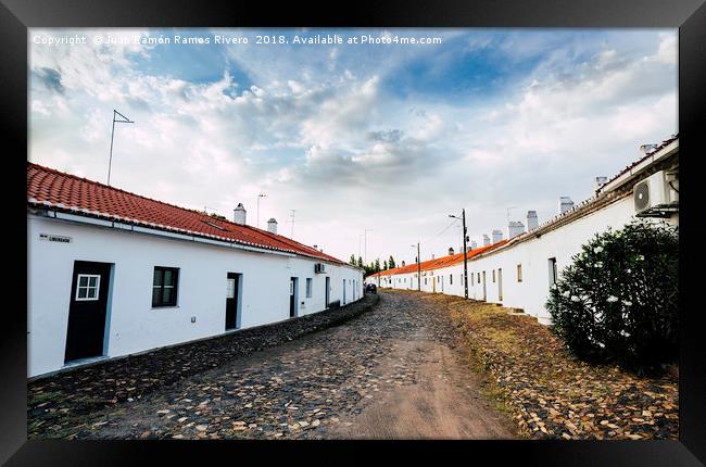 Stoned street with white facades and chimneys Framed Print by Juan Ramón Ramos Rivero