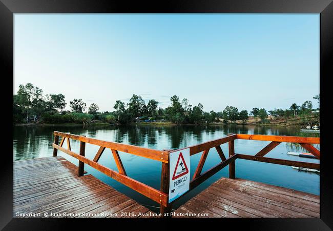 Wooden jetty with danger sign jumping into the wat Framed Print by Juan Ramón Ramos Rivero