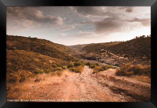 Very steep dirt road that leads to the Guadiana Ri Framed Print by Juan Ramón Ramos Rivero