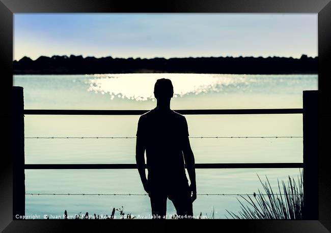 Silhouette guy standing  in the barbed wire fence Framed Print by Juan Ramón Ramos Rivero