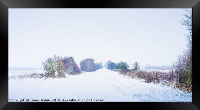 Looking down a Railway line in a Blizzard Framed Print by James Aston