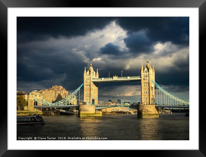 Tower bridge illuminated in a dark sky Framed Mounted Print by Claire Turner