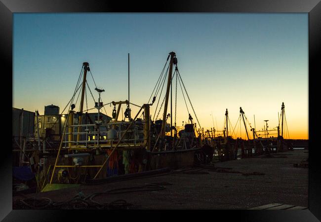 Silhouette of fishing boats Framed Print by Clive Wells