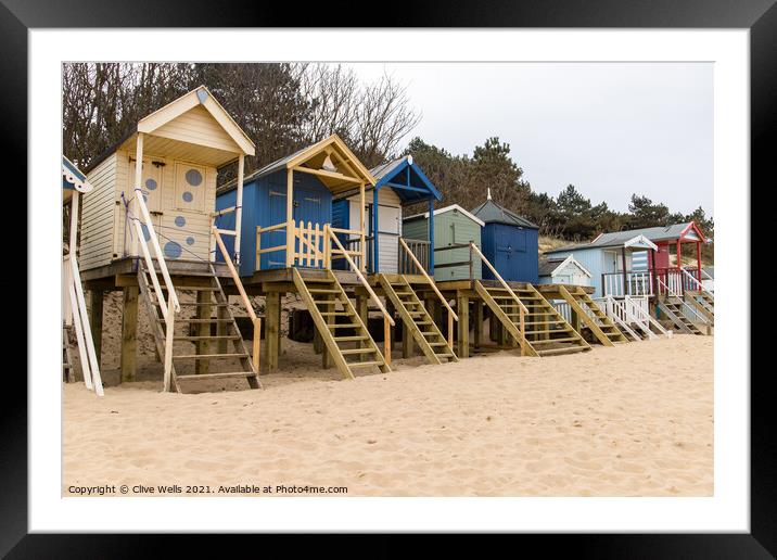 Beach huts above the sand Framed Mounted Print by Clive Wells