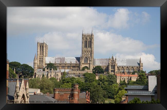 Lincoln Cathedral over the roof tops Framed Print by Clive Wells