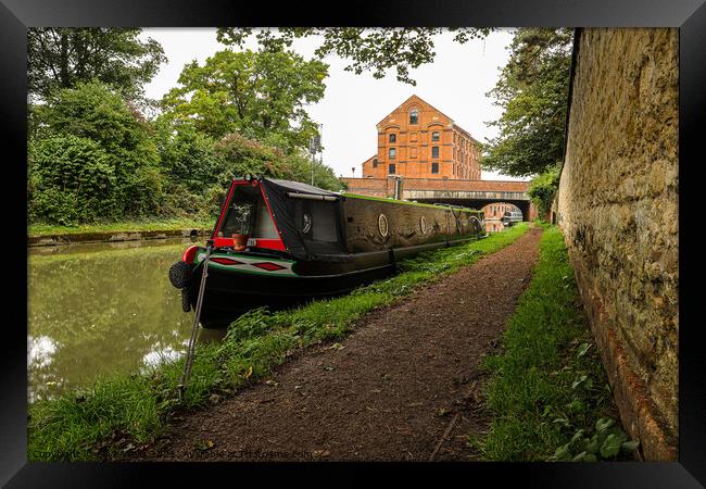 Lone narrowboat moored near the bridge Framed Print by Clive Wells