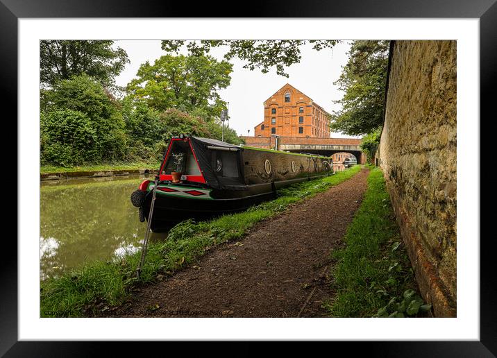 Lone narrowboat moored near the bridge Framed Mounted Print by Clive Wells