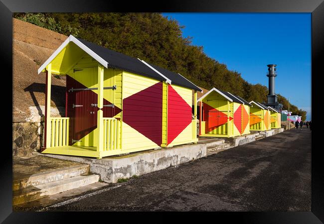 Bright beach huts on Folkestone sea front Framed Print by Clive Wells